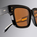 An image of the Cutler and Gross 1434 Square Sunglass frame detail close up of right lens and temple in grey background.