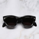 An image of the 9261 Cat Eye Sunglasses in Obsidian frame frontal view with arms closed marble background