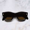 An image of the 9261 Cat Eye Sunglasses in Olive on Black frame frontal view with arms closed marble background