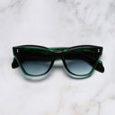 An image of the 9288 Cat Eye Sunglasses in Emerald Colour Studio frame frontal view with arms closed marble background