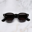 An image of the 9290 Round Sunglasses in Obsidian frame frontal view with arms closed marble background 