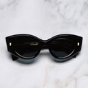 An image of the 9317 Cat Eye Sunglasses in Black on Crystal frame frontal view with arms closed marble background