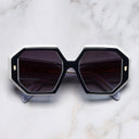 An image of the 9324 Square Sunglasses in Blue on White frame frontal view with arms closed marble background