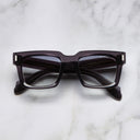 An image of the 9386 Square Sunglasses in Dark Grey frame frontal view with arms closed marble background