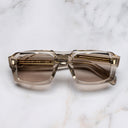 An image of the 9495 Rectangle Sunglasses in Sand Crystal frame frontal view with arms closed marble background