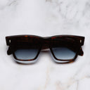 An image of the 9690 Square Sunglasses in Dark Turtle frame frontal view with arms closed marble background