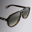 Still life image of 9782 Aviator Sunglasses in Dark Havana from the right side, close up of right lens and temple.