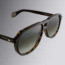 Still life image of 9782 Aviator Sunglasses in Dark Havana from the right side, close up of right lens and temple.