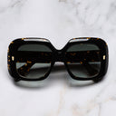 An image of the 9891 Rectangle Sunglasses in Havana frame frontal view with arms closed marble background