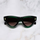 An image of the 9926 Cat Eye Sunglasses in Emerald Colour Studio frame frontal view with arms closed marble background