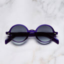 An image of the GR01 Round Sunglasses in Ink frame frontal view with arms closed marble background