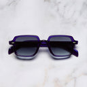 An image of the GR02 Rectangle Sunglasses in Ink frame frontal view with arms closed marble background