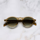 An image of the GR08 Round Sunglasses in Crystal Tobacco frame frontal view with arms closed marble background