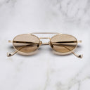 An image of the Ladbroke 1427 Oval Sunglasses in Gold frame frontal view with arms closed marble background