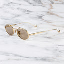 An image of the Ladbroke 1427 Oval Sunglasses in Gold frame side view with arms open marble background