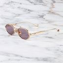An image of the Ladbroke 1427 Oval Sunglasses in Pink Gold frame side view with arms open marble background