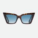 An image of the Cutler and Gross Valentina 002 Cat Eye Sunglasses in tortoiseshell with blue lenses frame frontal view with arms open on a white background.