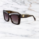 An image of the Cutler and Gross Akira 001 Cat Eye Tortoiseshell Sunglasses with Brown lenses frame side view with arms open and gold details on temples.