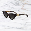Sunglasses with a brand logo on a marble background