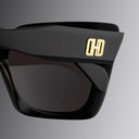 An image of the Cutler and Gross Akira 001 Cat Eye Sunglasses frame detail close up of right hinge and temple with gold logo.