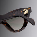 Sunglasses with a gold logo on a gray background