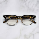 An image of the 0004 Kingsman Round Opticals in Black/Havana frame frontal view with arms closed marble background
