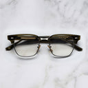 An image of the 0004 Kingsman Round Opticals in Olive frame frontal view with arms closed marble background