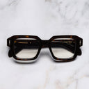 An image of the The Great Frog Bones Link Square Optical Glasses in Havana frame frontal view with arms closed marble background