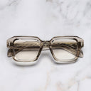 An image of the The Great Frog Bones Link Square Optical Glasses in Sand Crystal frame frontal view with arms closed marble background