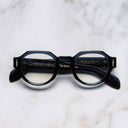 An image of the The Great Frog Lucky Diamond I Round Glasses in Deep Blue frame frontal view with arms closed marble background