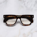 An image of the The Great Frog Lucky Diamond II Rectangle Optical Glasses in Dark Turtle frame frontal view with arms closed marble background