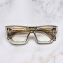 An image of the The Great Frog Love And Death Cat Eye Glasses in Sand Crystal frame frontal view with arms closed marble background