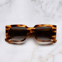 An image of the The Great Frog Mini Reaper Square Sunglasses in Leopard Havana frame frontal view with arms closed marble background