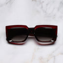 An image of the The Great Frog Mini Reaper Square Sunglasses in Bordeaux frame frontal view with arms closed marble background