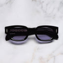 An image of the The Great Frog Soaring Eagle Rectangle Sunglasses in Black frame frontal view with arms closed marble background