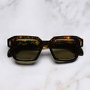 An image of the The Great Frog Bones Link Rectangle Sunglasses in Brush Stroke frame frontal view with arms closed marble background