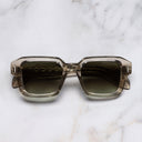 An image of the The Great Frog Bones Link Rectangle Sunglasses in Sand Crystal frame frontal view with arms closed marble background