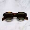 An image of the The Great Frog Lucky Diamond I Round Sunglasses in Havana frame frontal view with arms closed marble background