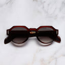 An image of the The Great Frog Lucky Diamond I Round Sunglasses in Red Jed frame frontal view with arms closed marble background