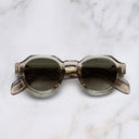 An image of the The Great Frog Lucky Diamond I Round Sunglasses in Sand Crystal frame frontal view with arms closed marble background