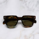 An image of the The Great Frog Lucky Diamond I Round Sunglasses in Brush Stroke frame frontal view with arms closed marble background