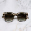 An image of the The Great Frog Lucky Diamond II Rectangle Sunglasses in Sand Crystal frame frontal view with arms closed marble background