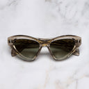 An image of the The Great Frog Mini Cat Eye Sunglasses in Sand Crystal frame frontal view with arms closed marble background