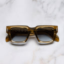 An image of the The Great Frog Titan Square Sunglasses in Crystal Tobacco frame frontal view with arms closed marble background