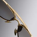 An image of the Cutler and Gross The Great Frog Paterson Aviator Sunglasses in Gold/Silver frame detail close up from left side view.