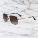 An image of the Cutler and Gross The Great Frog Ganton Navigator Sunglasses in Silver/Gold frame side view with arms open marble background.