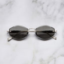 An image of the Cutler and Gross The Great Frog Carol Rectangular Sunglasses in silver frame frontal view with arms closed marble background.