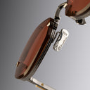 An image of the Cutler and Gross The Great Frog Carol Rectangular Sunglasses frame detail close up from left side view.