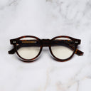 An image of the 1378 Blue Light Filter Optical Round Glasses (Small) in Dark Turtle frame frontal view with arms closed marble background