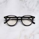 An image of the 0710 Kingsman Optical Round Glasses in Black frame frontal view with arms closed marble background